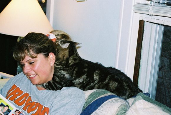 Lisa getting a massage from Malachy.  Stop over after a hard day at work and unwind with the massaging Murray cat!  (August, 2005)© Carolyn S. Murray 2005