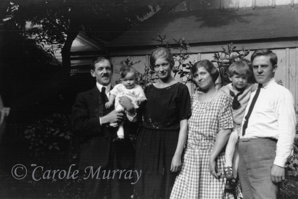 This may be Joseph Karres (1885 - 1930) holding daughter Trudy (1923 - 2007) and standing next to wife Charlotte (Lotte) Schuster.  The other couple may be Elisabeth Schuster Loew (1900 - 1981)and her