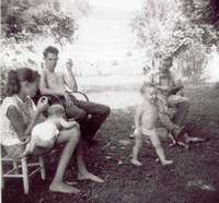 Summertime was often spent on the front porch or in the front yard.  Here's a shot from the summer of 1958.Left to right:  Daughter Eva holding granddaughter, Carole, son Billy, Brad and granddaughter