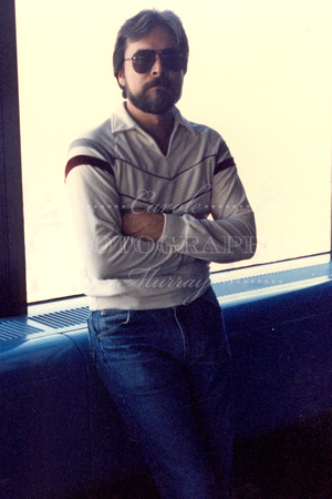 Larry wasn't too crazy about the elevator ride up to the observation deck, considering the floors were glass .... but he struck this very casual pose for the camera.  (October 1986)