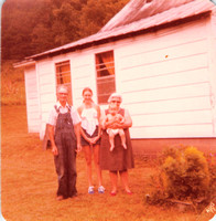 1977:  Papaw, Mamaw, Chas and I standing by the side of the house.