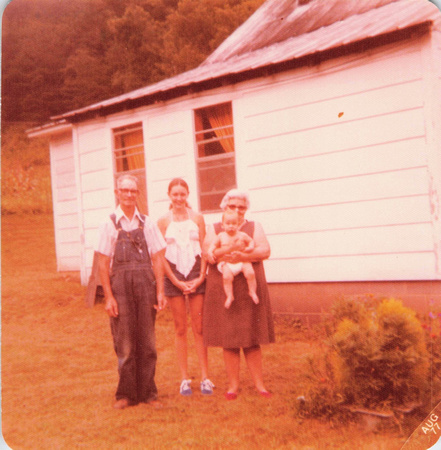 1977:  Papaw, Mamaw, Chas and I standing by the side of the house.