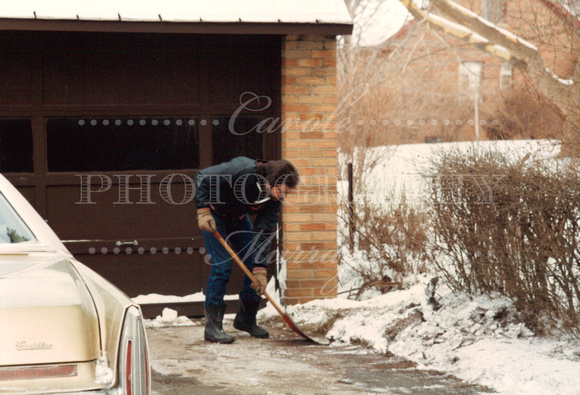 While the boys played, Dad shoveled snow.
