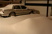 A night-time shot -- and they tell us more is on the way.  I'm definitely staying home, but Larry is going to have to dig this car out about 3:30 a.m. and hit the roads.  (February 13, 2007)© Carolyn