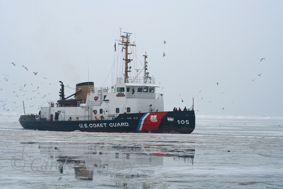 While we were taking photos of the Rock and Roll Hall of Fame, we heard this Coast Guard boat cutting through the ice on Lake Erie.  (January 2010)© Carolyn S. Murray 2010