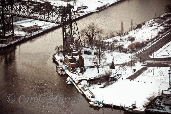 This is the Eagle Street bridge, in it's up position, next to the Fire Station on the Cuyahoga River, Cleveland, Ohio.  (January 2012)