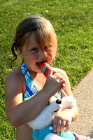 The ice cream truck came by and Ava looks pretty happy with her selection!  (June 9, 2008)© Carolyn S. Murray 2008